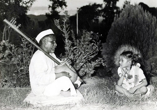 Young Satpal ji Maharaj listening to devotional songs sung by a blind singer.